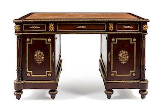 * An Empire Style Gilt Metal Mounted Mahogany Pedestal Desk Height 31 1/2 x width 50 x depth 27 1/2 inches.