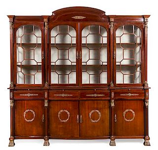* An Empire Style Gilt Metal Mounted Mahogany Breakfront Bookcase Height 88 x width 91 x depth 19 inches.