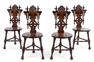 A Set of Four Continental Parcel Ebonized and Mother-of-Pearl Inlaid Walnut Hall Chairs Height 39 1/2 inches.