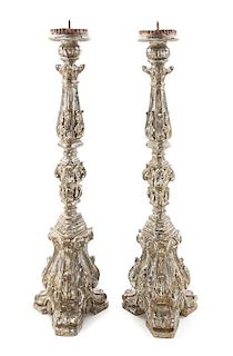 A Pair of Venetian Silvered and Carved Wood Prickets Height 30 3/4 inches.