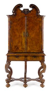 A Continental Walnut Cabinet on Stand Height 85 3/4 x width 43 x depth 15 1/4 inches.