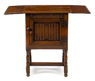 A Gothic Revival Oak Drop-Leaf Cabinet Height 30 3/8 x width 38 (open) x depth 14 1/4 inches.