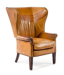A George III Style Leather-Upholstered Wingback Chair Height 45 1/4 x width 32 3/4 x depth 35 inches.