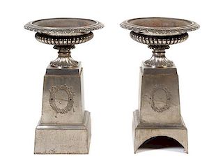 * A Pair of Victorian Style Polished Iron Urns Height 32 inches.