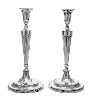 A Pair of George III Silver Candlesticks, John Schofield, London, 1781-2, the fluted candle cup above the fluted tapering stem e