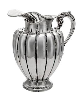A South American Water Pitcher, Likely Peruvian, 20th Century, of baluster form, having an acanthus capped handle and a lobed bo