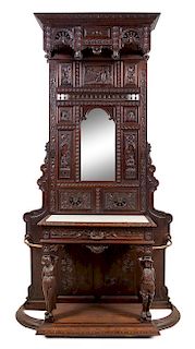 A Renaissance Revival Carved Oak Hall Tree Height 106 x width 54 1/2 x depth 17 inches.