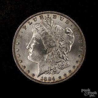 Silver Morgan dollar coin, 1884, MS-63 to MS-64.