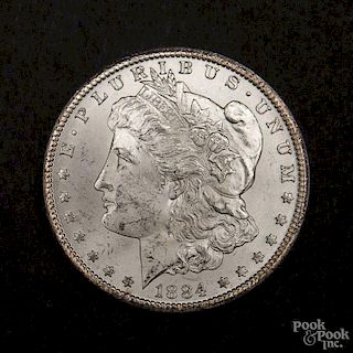 Silver Morgan dollar coin, 1884 CC, MS-63 to MS-64.