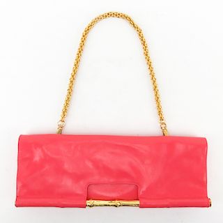 Trina Turk Salmon Pink Patent Leather Clutch. Gold-tone hardware and shoulder chain. Magnetic closu