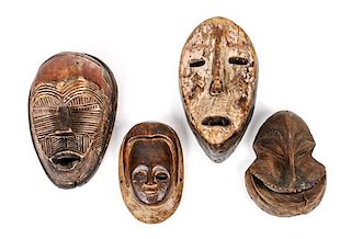 Four African Carved Wood Masks Height of largest 10 inches