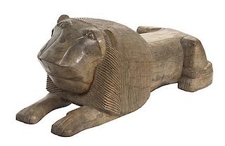 A Persian Carved Wood Figure of a Recumbent Lion, Length overall 55 1/4 inches.