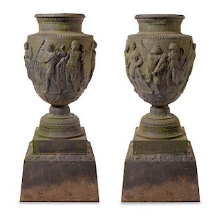 A Pair of Cast Metal Garden Urns Height overall 54 inches.
