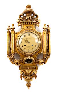 A Swedish Giltwood Cartel Clock Height 26 inches.