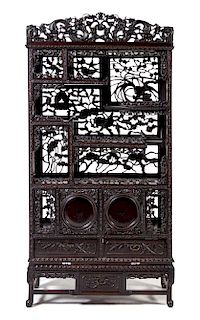 * A Japanese Carved Hardwood Etagere Height 65 1/2 x width 32 x depth 11 1/2 inches.