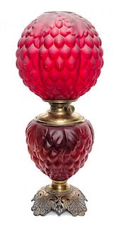 A Victorian Cranberry Glass Oil Lamp, Height 23 inches.