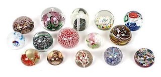 A Collection of Fifteen Glass Paperweights, Diameter of largest 3 inches.