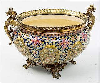 * A Continental Gilt Metal Mounted Faience Jardiniere Height 10 1/4 x width 15 inches.