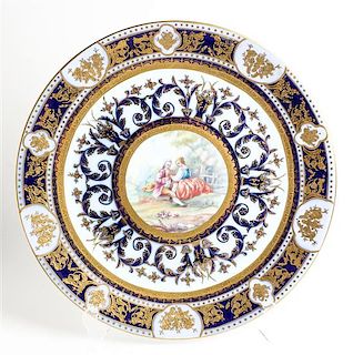 A German Polychrome and Parcel Gilt Porcelain Charger Diameter 16 3/4 inches.