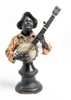 * A Painted Cast Metal Bust of a Banjo Player Height 10 3/4 inches.