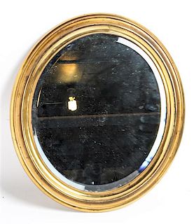 An Oval Gilt Metal Mirror Height 15 x width 13 inches.