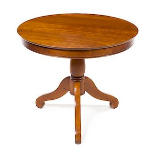 * A French Carved Wood Occasional Table Height 28 1/4 x diameter 33 1/2 inches.
