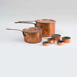 Two Large Copper Sauce Pans, with Steel Handles and Covers and a Nest of Five Small Copper Sauce Pans with Brass Handles