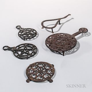 Four Cast Iron and One Wrought Iron Trivets