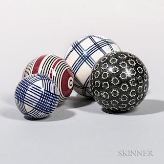 Four Glazed Ceramic Carpet Balls