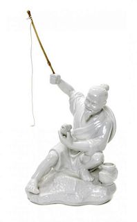 A Chinese Blanc de Chine Figure of a Fisherman, Height overall 10 1/2 inches.