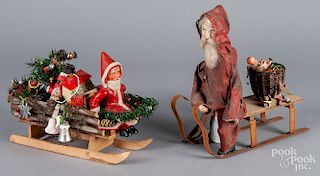 Two Santa Claus in sleigh toys