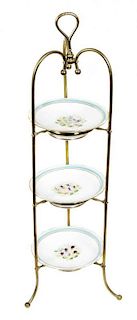 A Victorian Brass and Porcelain Three-Tier Muffin Stand, Height 37 x diameter of plates 9 1/4 inches.