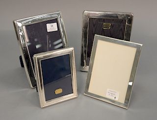 Group of four sterling silver picture frames, one marked Tiffany & Co. Makers, sterling silver 23472. sizes from 6 1/2" x 4 3/4" to...