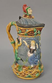 Mintons Majolica tower pitcher with cover, dancing figure relief and joker bust finial (chip on cover). ht. 13in.