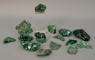 Fifteen carved malachite polished stones. wd. 1 3/4in. to 5in.