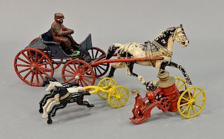 Two cast iron horse drawn toys including single horse with wagon and rider and a small triple horse with fire pumper wagon. lg. 5 1/...