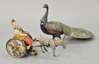 Two tin wind up toys including German Lehmann tin clown and donkey wind up toy and an antique German Pao Pao Ebo peacock tin wind up...
