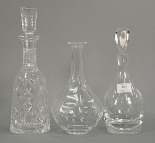 Three crystal decanters, lalique, Steuben with stopper, and a Waterford with stopper. ht. 9 1/2in., 11in. & 13in.