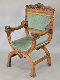Oak carved armchair with lion's head hand rests.