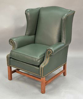 Ethan Allen green leather upholstered wing chair.