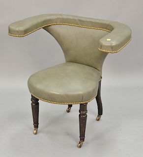 Unusual leather upholstered armchair with turned legs.