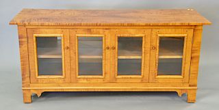 Custom tiger maple TV cabinet, signed on reverse Youngstown, Ohio, J.L. Treharn Co. Inc. ht. 27 1/2in., wd. 60in.