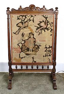 A Victorian Walnut and Tapestry Upholstered Fire Screen, Height 44 1/2 x width 26 inches.