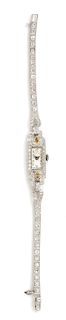 * An Art Deco Platinum, Diamond and Colored Diamond Wristwatch, Croton, 13.10 dwts.