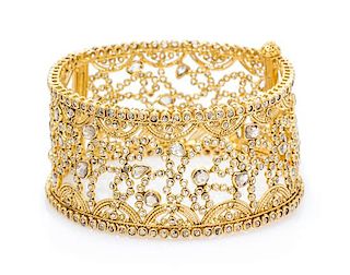 A High Karat Yellow Gold and Diamond Bangle Bracelet, 37.60 dwts.