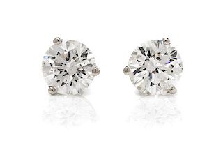 A Pair of 14 Karat White Gold and Diamond Stud Earrings, 0.60 dwts.