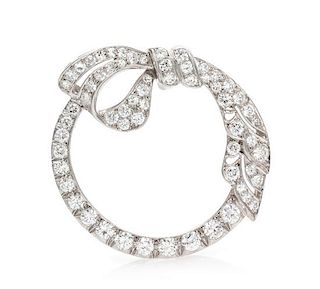 A Platinum and Diamond Circle and Bow Pendant/Brooch, 5.45 dwts.