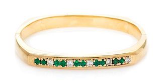 A Yellow Gold, Diamond, and Emerald Bangle Bracelet, 24.10 dwts.