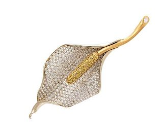 An 18 Karat Yellow Gold, 14 Karat White Gold, Diamond and Colored Diamond Calla Lily Brooch, 17.60 dwts.