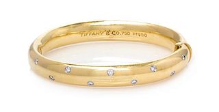 * An 18 Karat Yellow Gold, Platinum and Diamond 'Etoile' Bangle Bracelet, Tiffany & Co., 28.80 dwts.